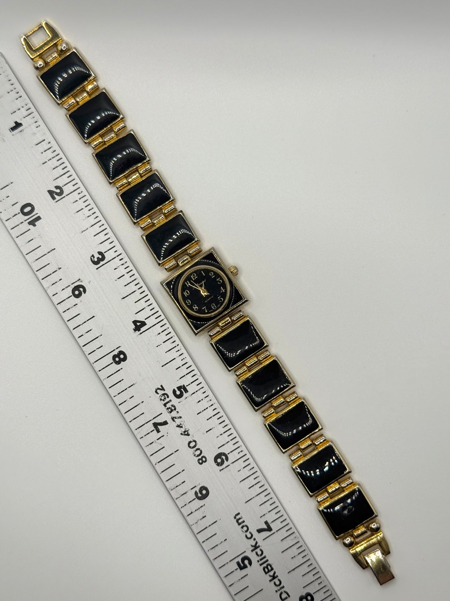 nonworking gold tone black enamel watch