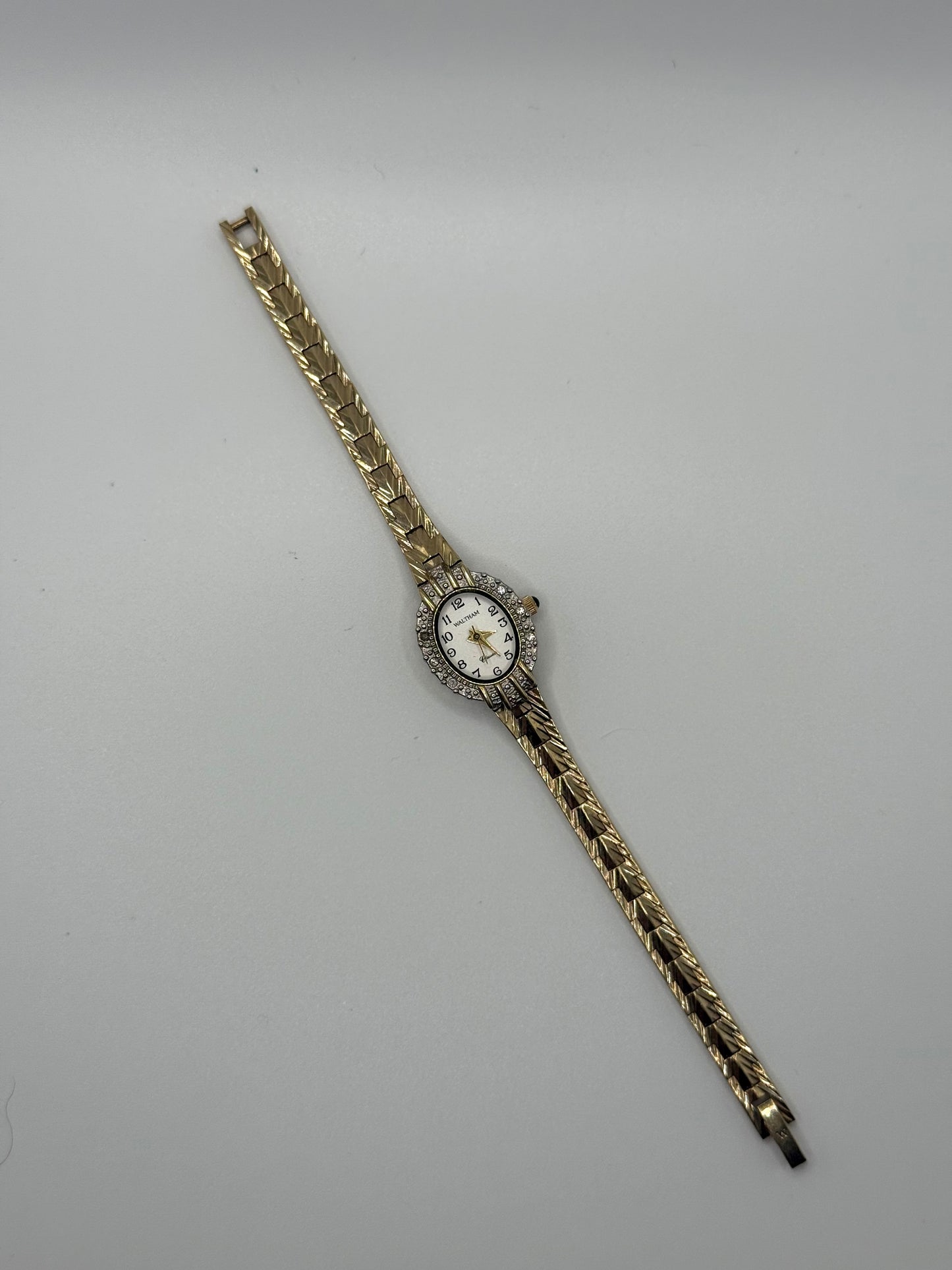working gold tone diamond bezel watch