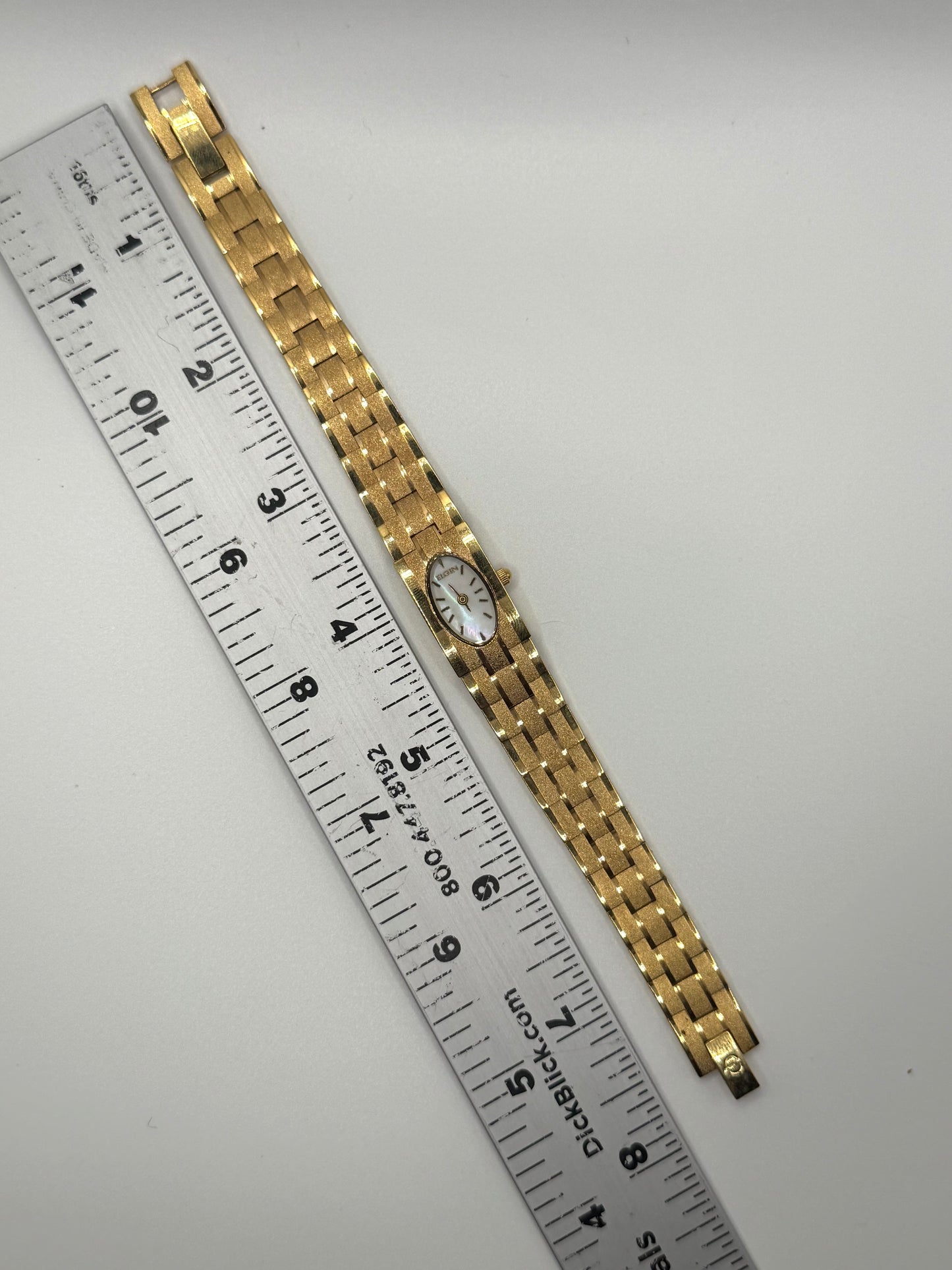 working gold tone oval dial watch