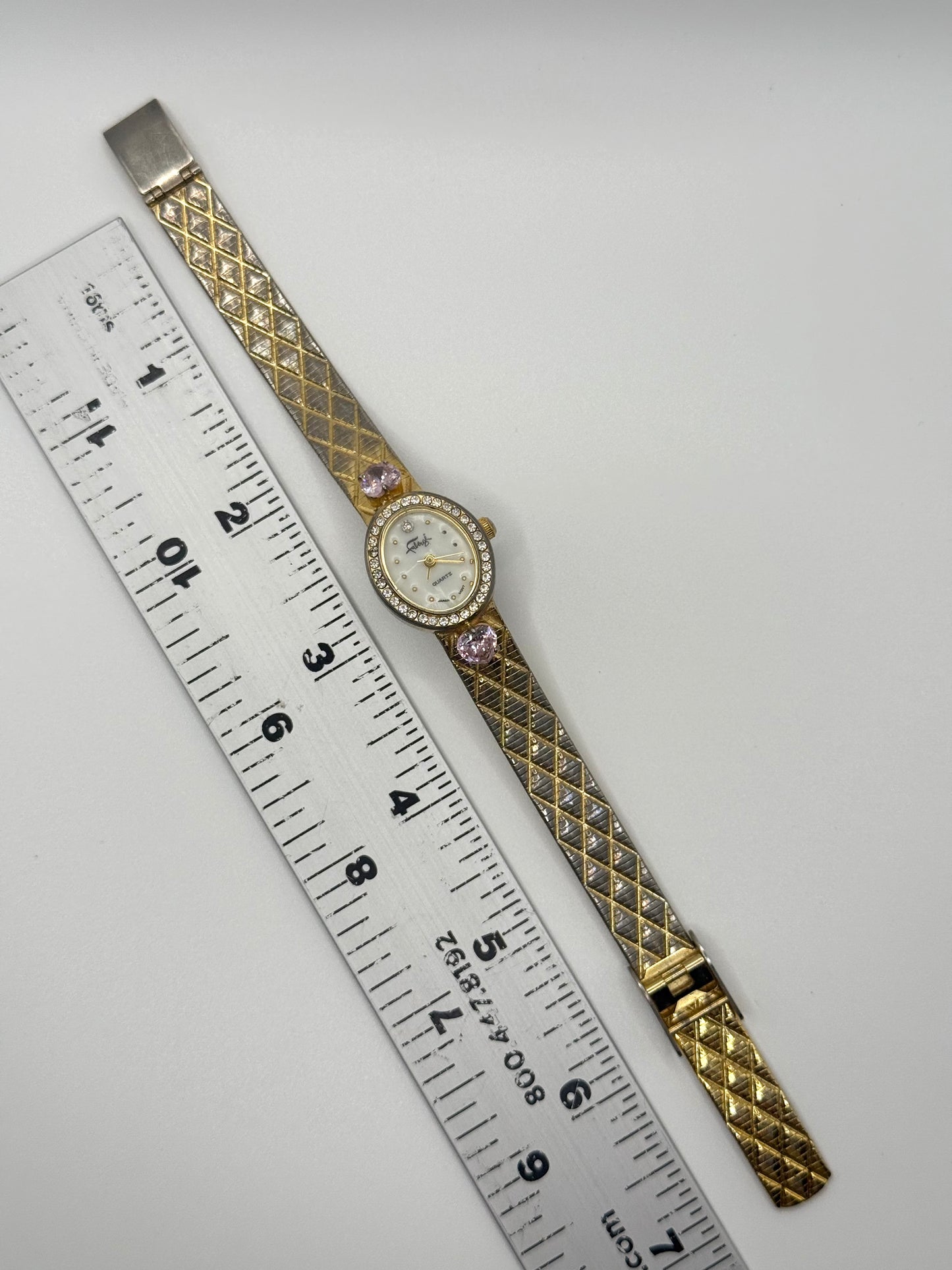 working gold tone pink gemstone watch