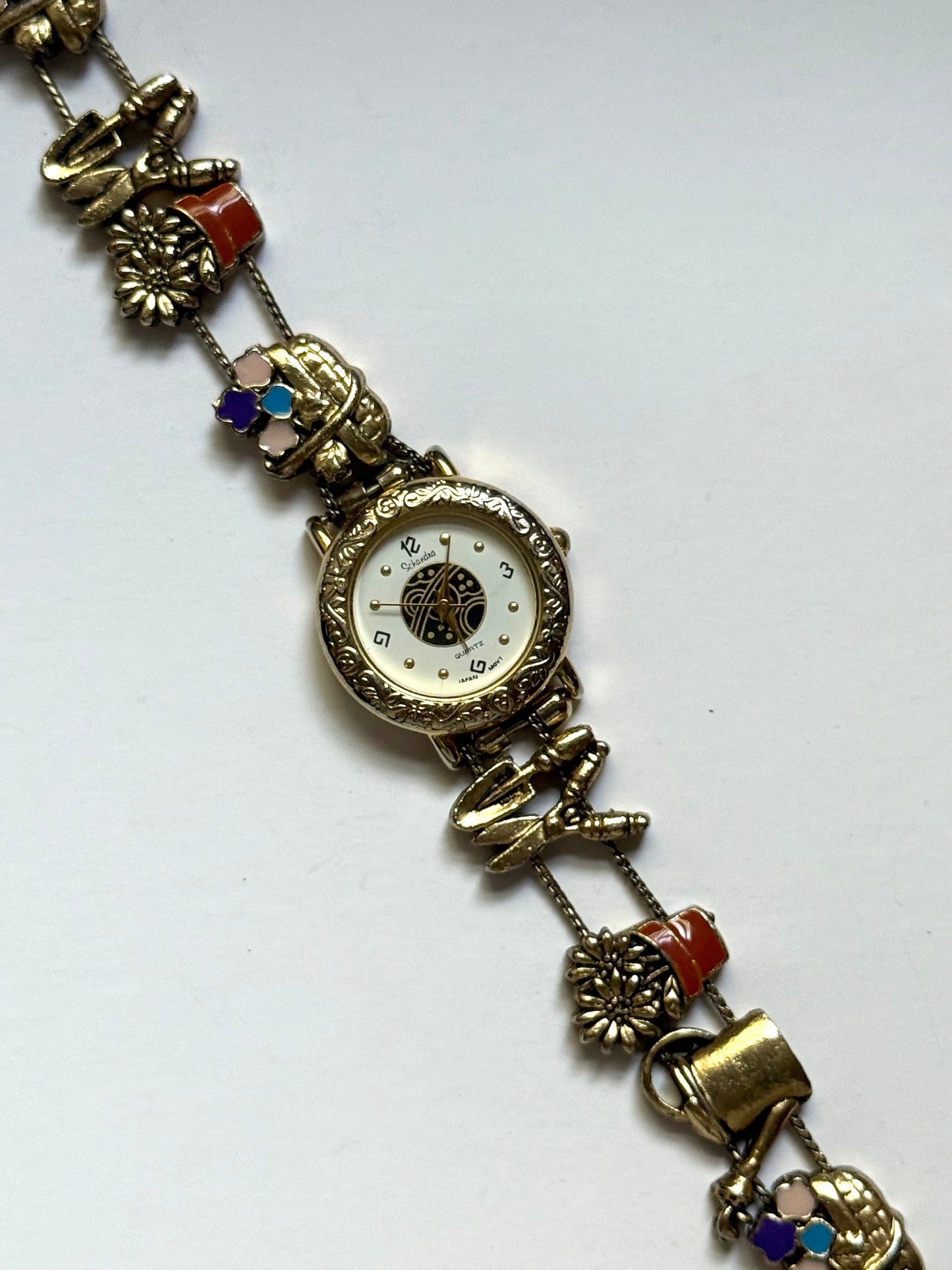 working gold tone gardening slide charm watch