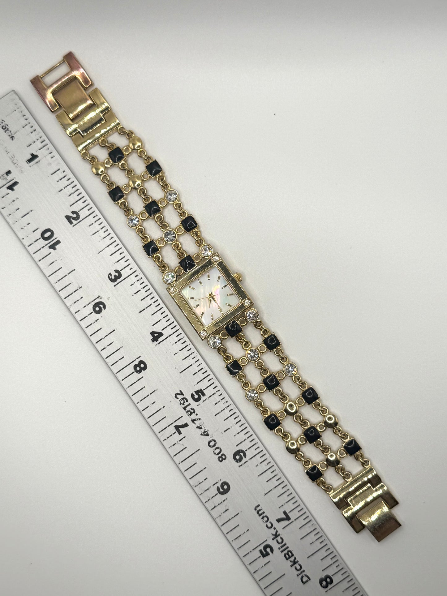 working gold tone black enamel and rhinestone watch