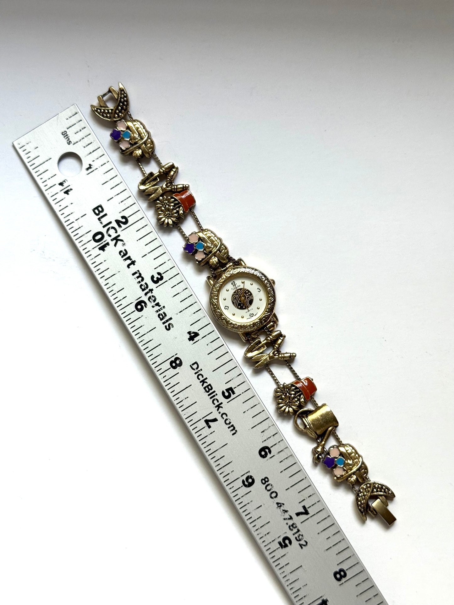 working gold tone gardening slide charm watch