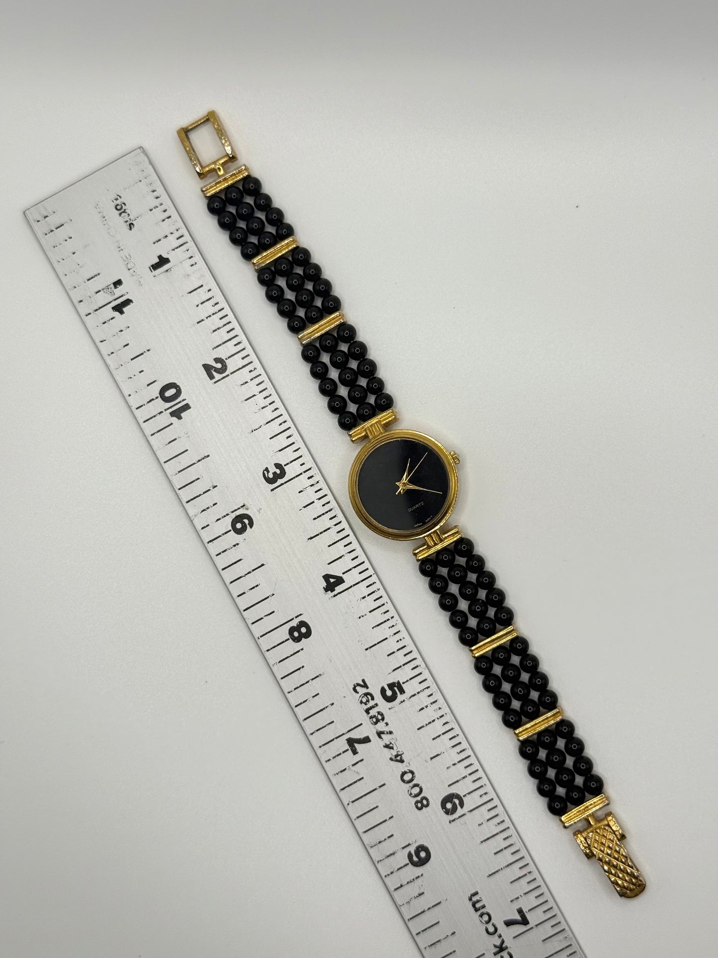 working gold tone black beaded pearl style watch