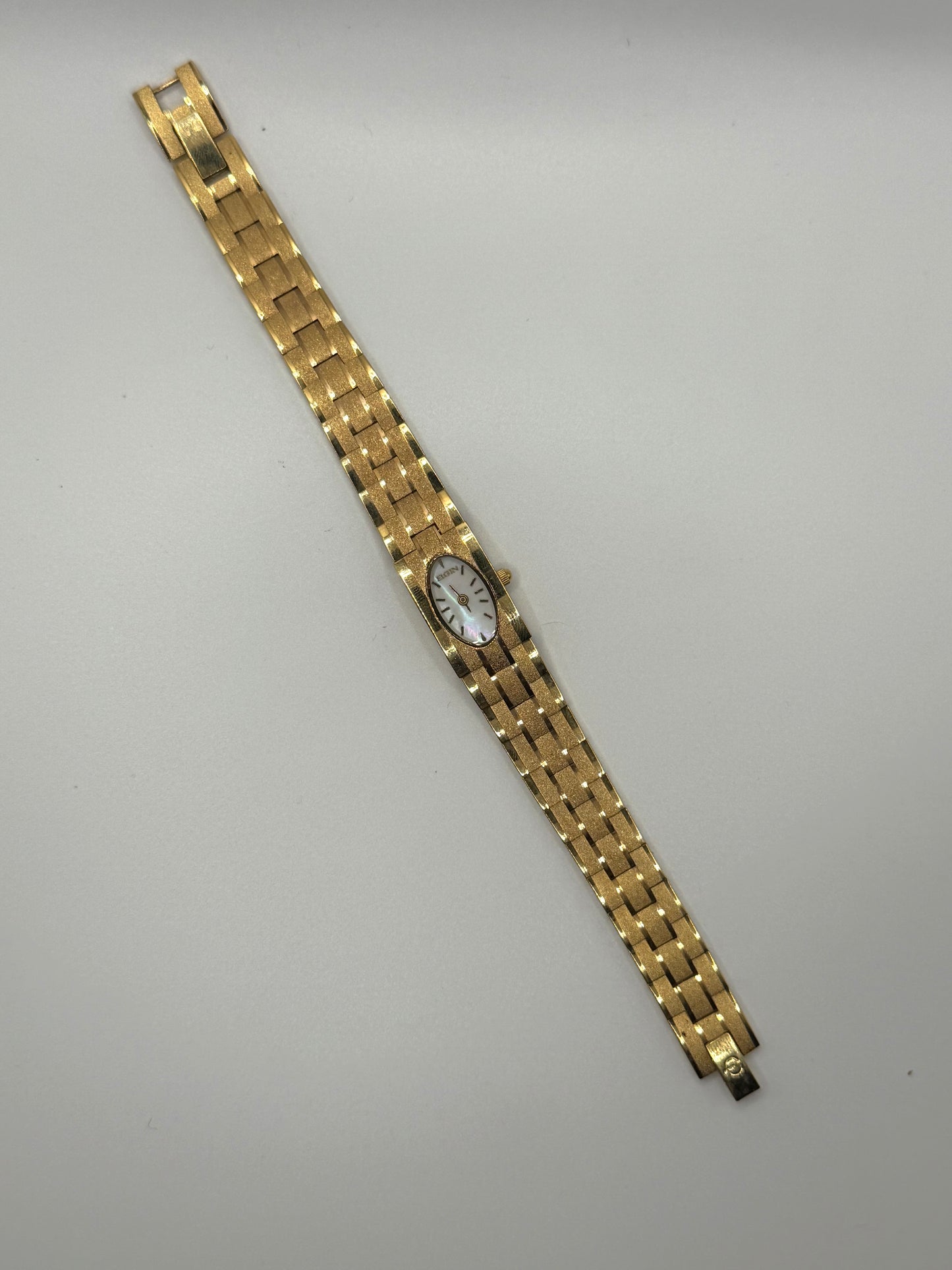 working gold tone oval dial watch