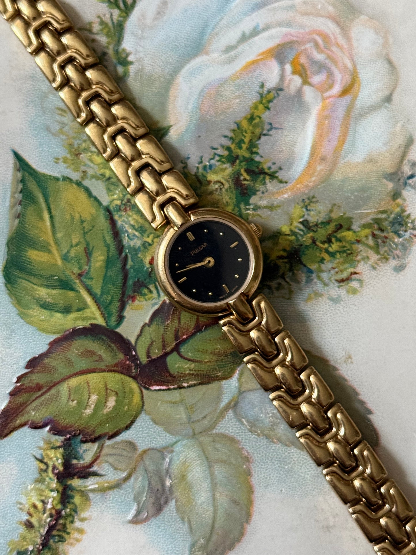 working gold tone black dial watch