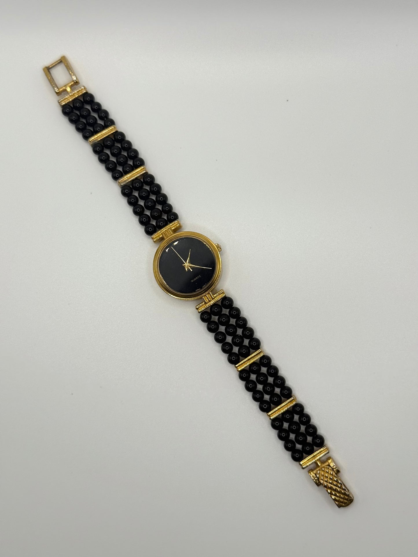 working gold tone black beaded pearl style watch