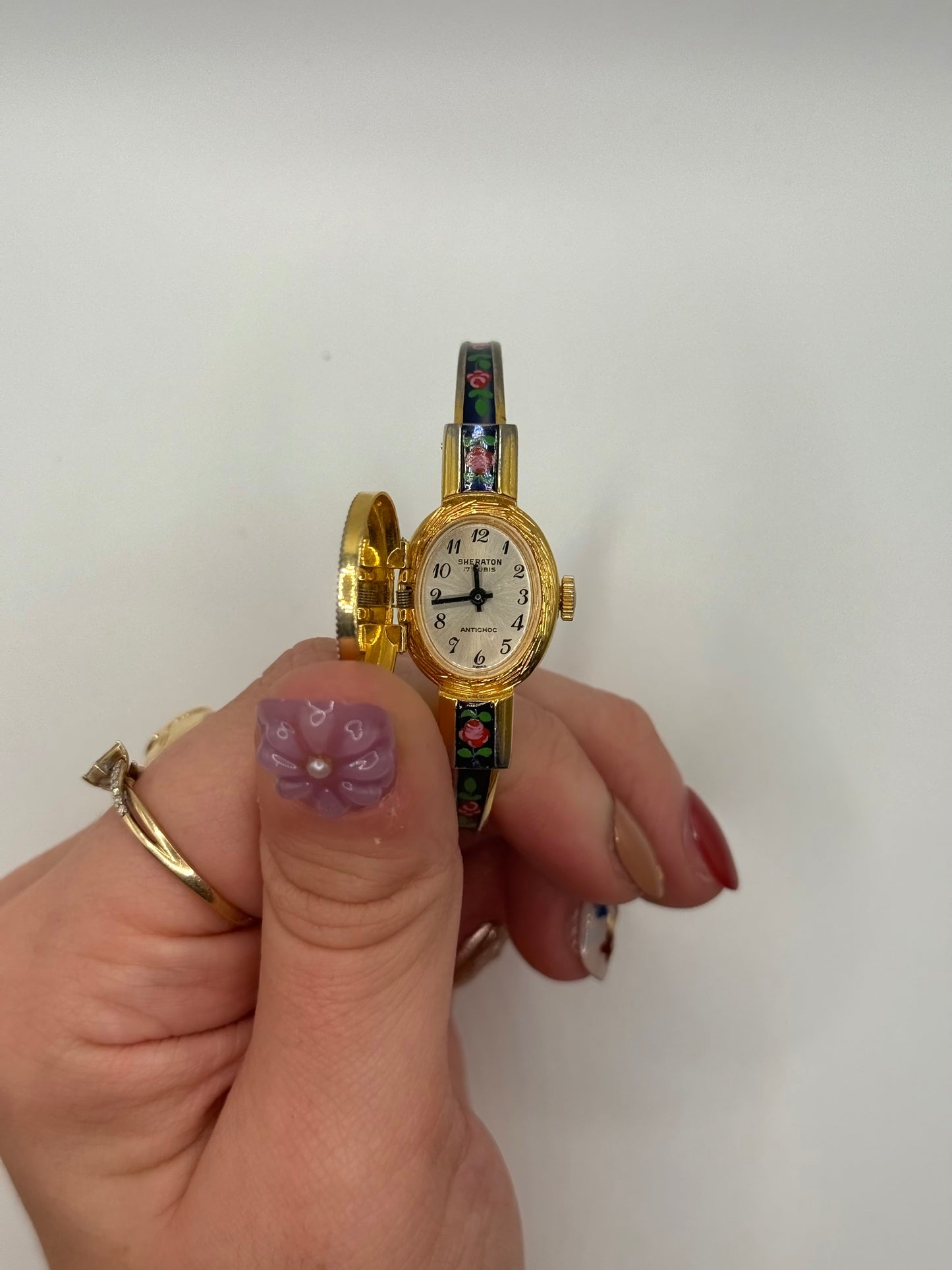 working gold tone wind up floral peek a boo watch
