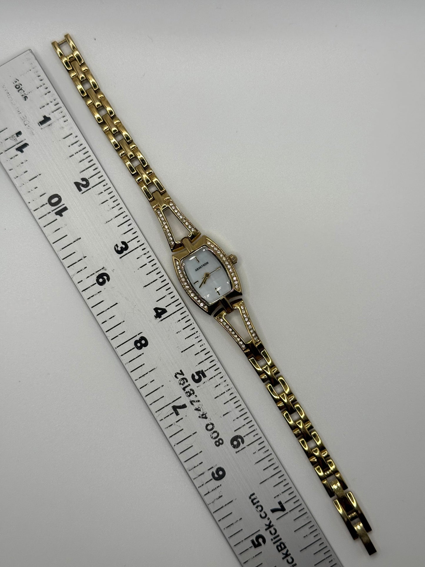 working gold tone crystal bezel watch