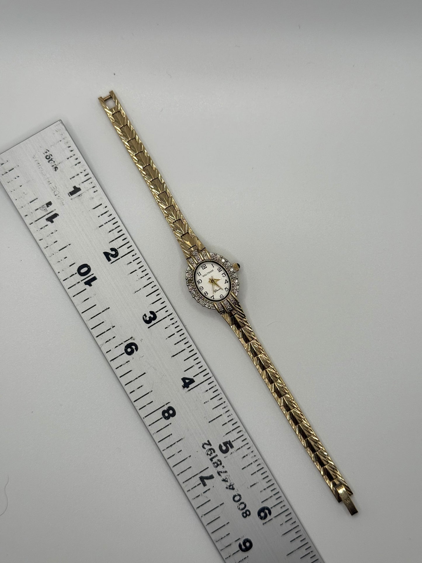 working gold tone diamond bezel watch