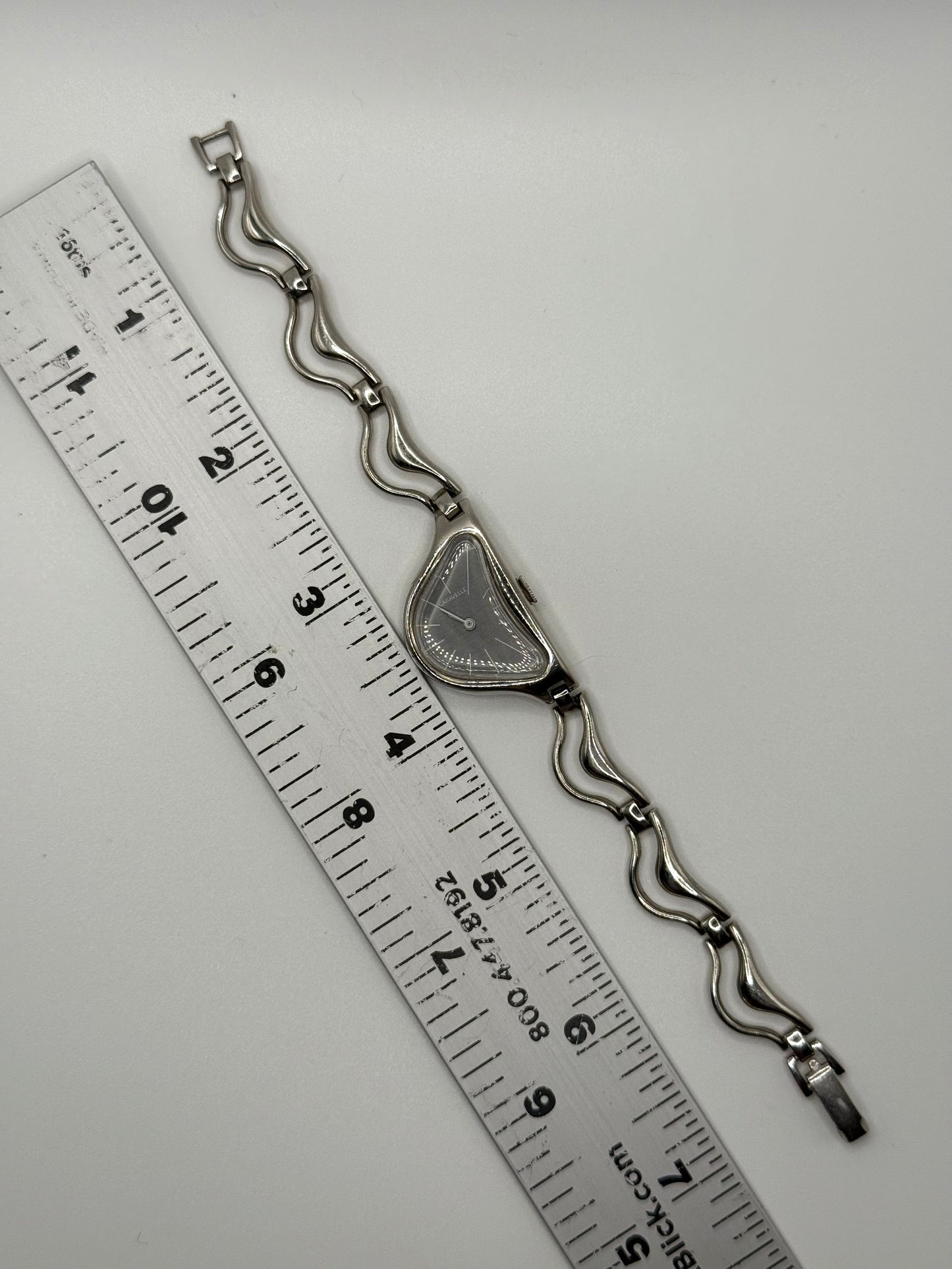 working silver tone wind up half moon watch