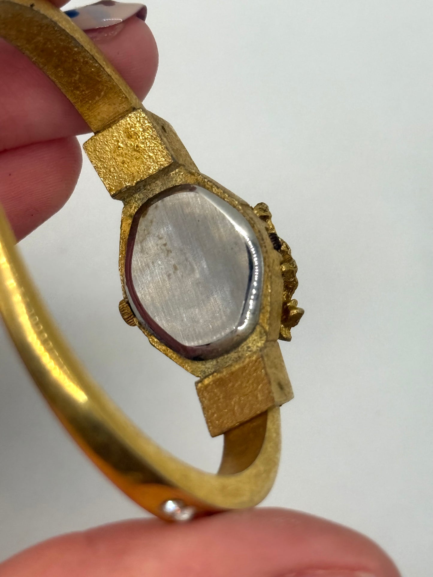 working gold tone peek a boo watch