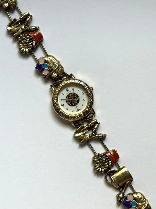 working gold tone gardening slide charm watch