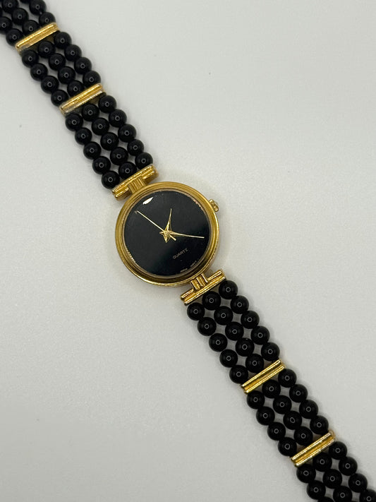 working gold tone black beaded pearl style watch
