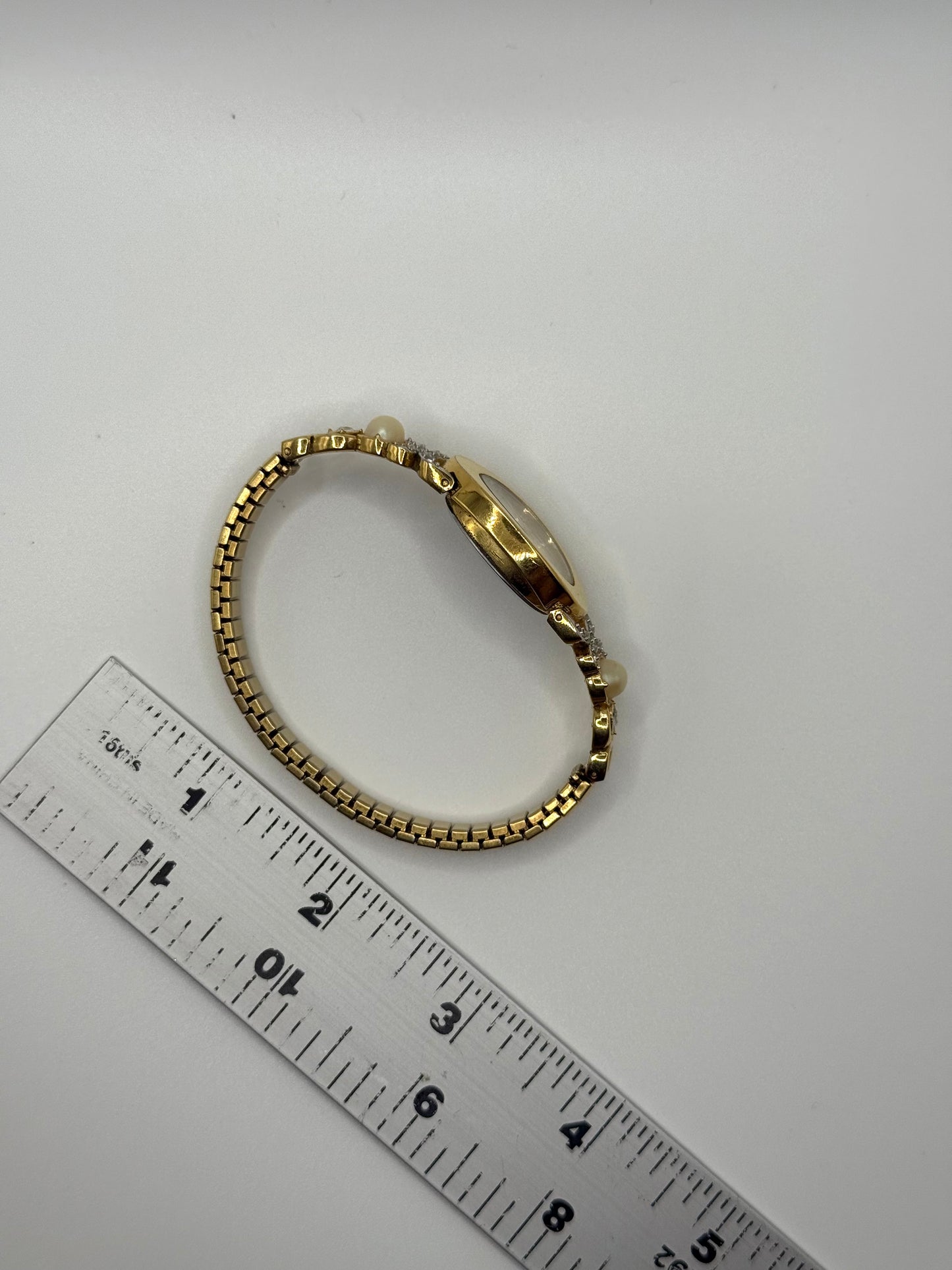 working gold tone pearl watch