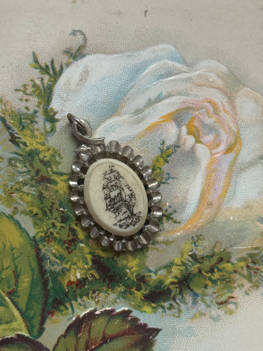 silver tone scrimshaw style ship pendant