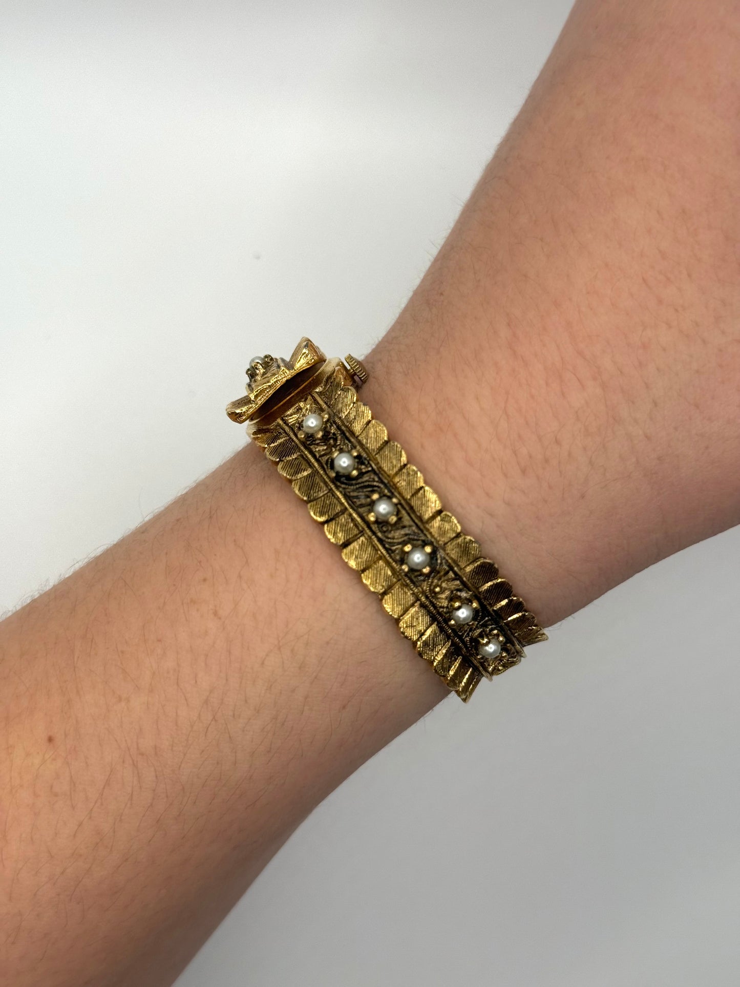 nonworking gold tone pearl band peek a boo watch