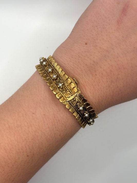 nonworking gold tone pearl band peek a boo watch