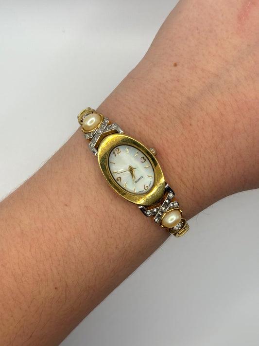 working gold tone pearl watch